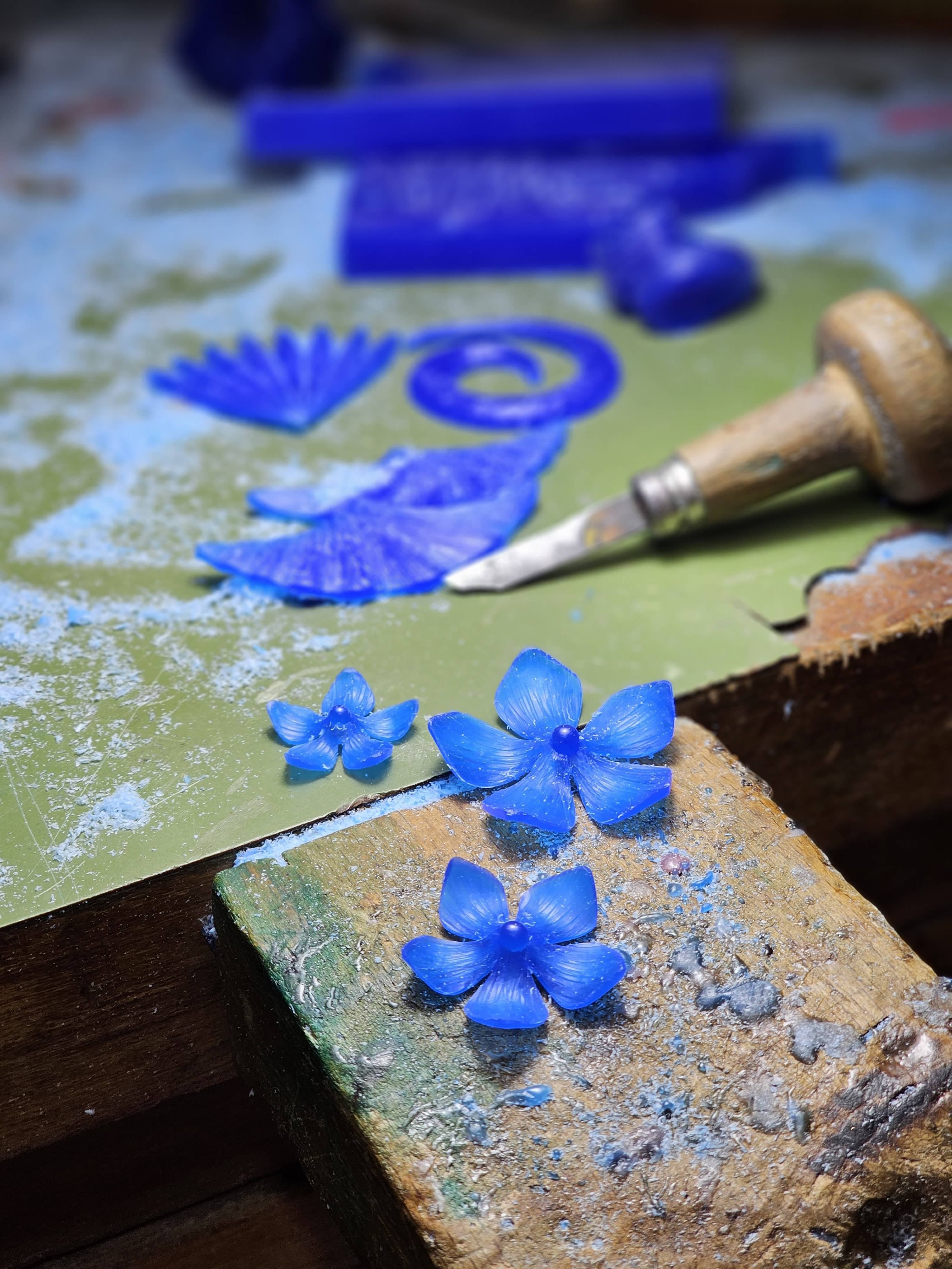 Blue wax flower models on the carver's bench